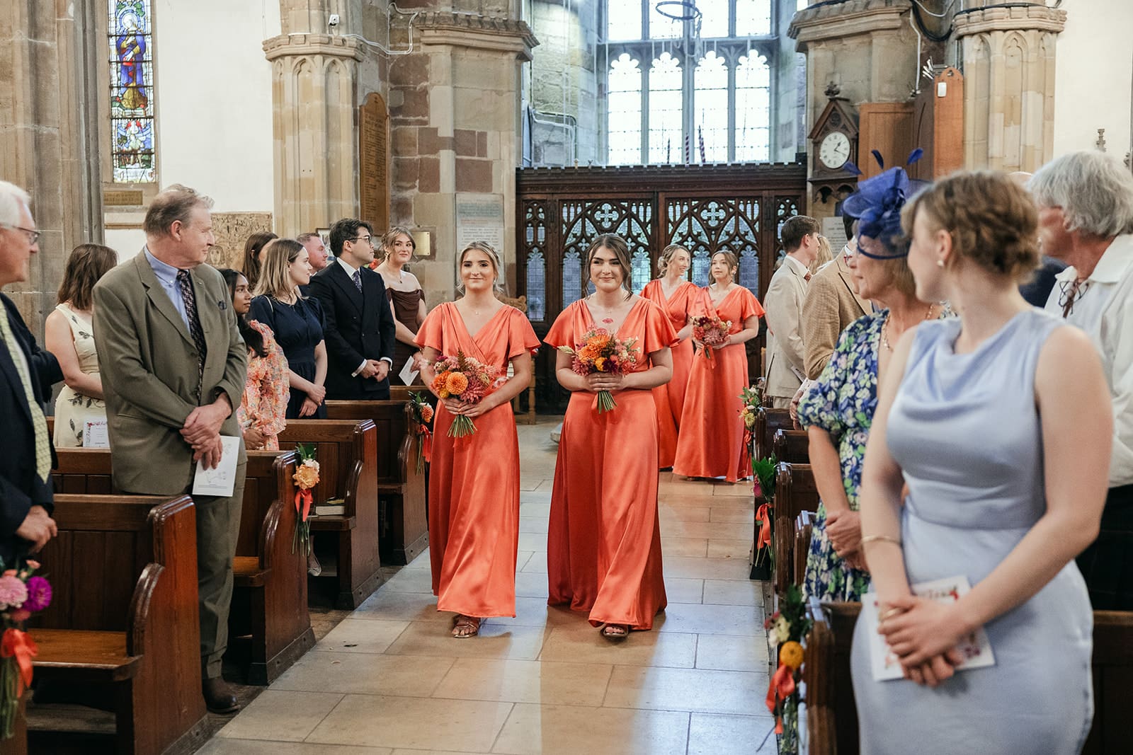 Bridesmaids walking down the aisle at St Helen’s Church Ashby-de-la-Zouch