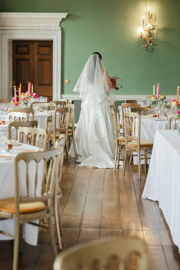 Bride looking around the wedding breakfast room at Staunton Harold Hall