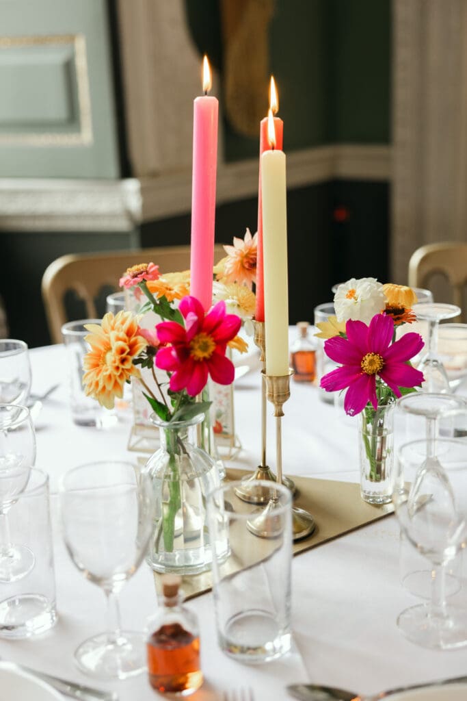 Elegant wedding table setting with candles and florals at Staunton Harold Hall