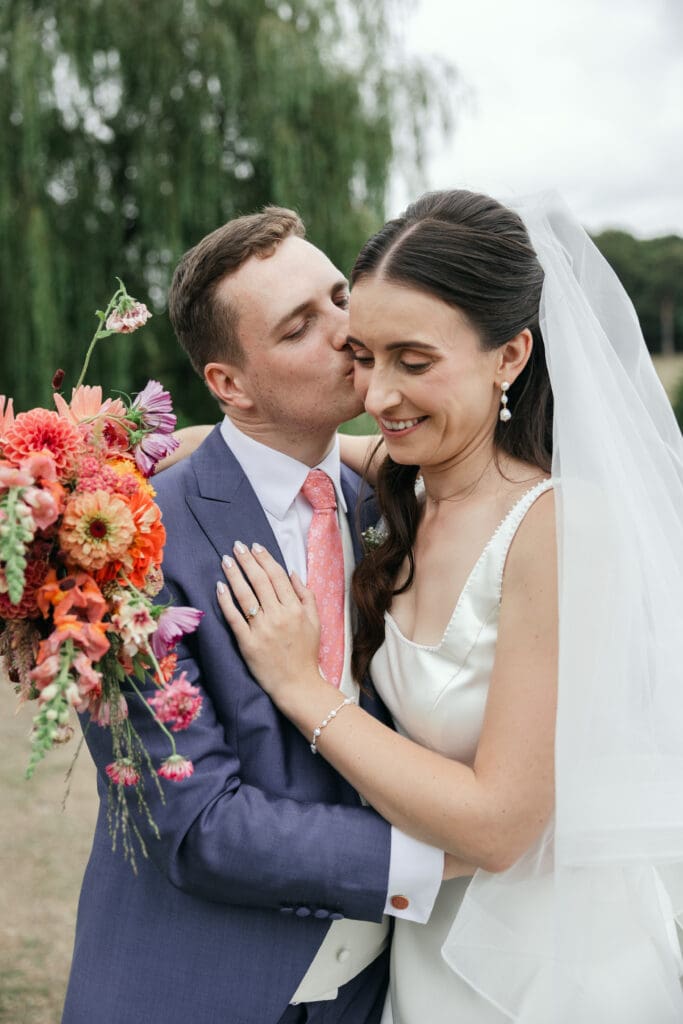 Bride and groom photographed by a Staunton Harold Hall wedding photographer in the gardens