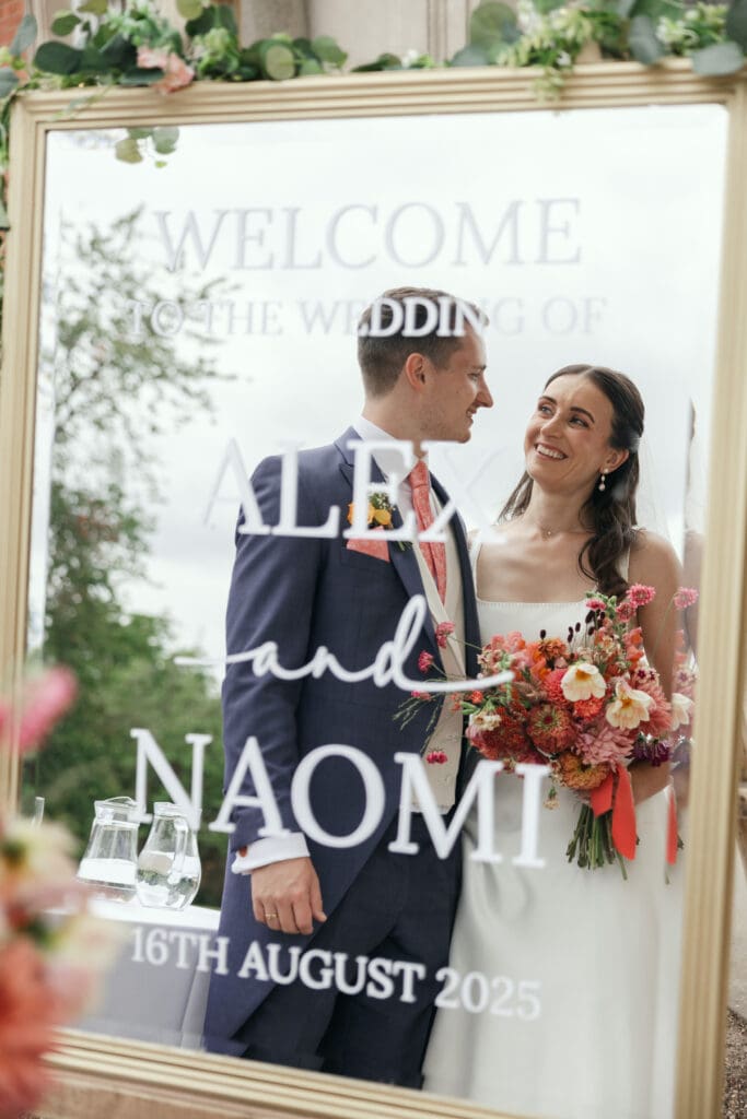 Couple posing in front of Staunton Harold Hall’s grand entrance
