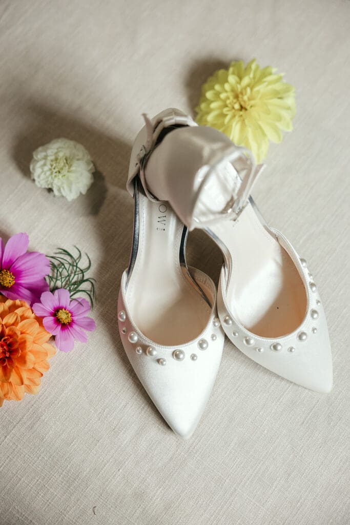 Bride's shoes, classy with pearls, styled with florals around