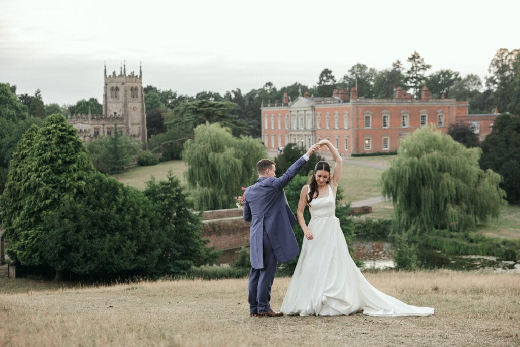 Wedding couple sharing a quiet moment in the parkland at Staunton Harold Hall