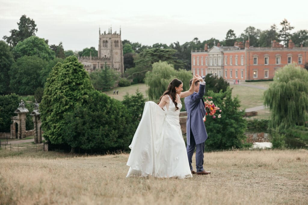 Wedding couple sharing a quiet moment in the parkland at Staunton Harold Hall
