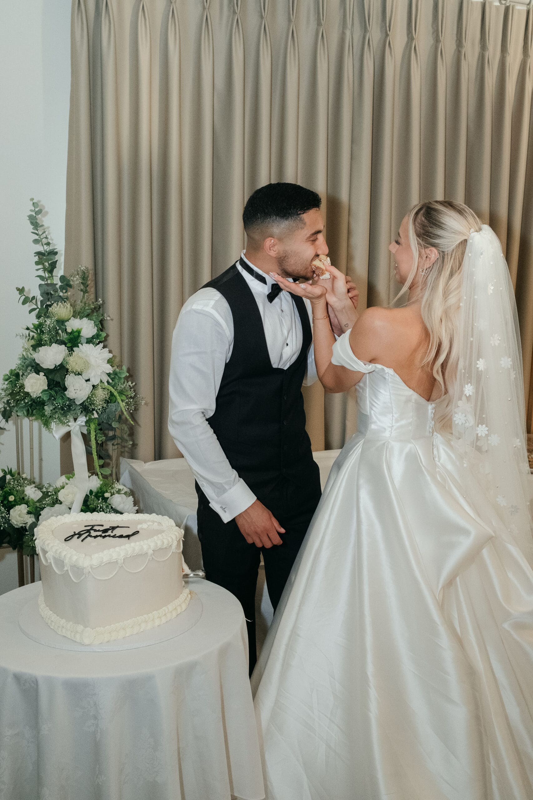 Bride and groom cutting their wedding cake at The Hop Rooms in Wisbech