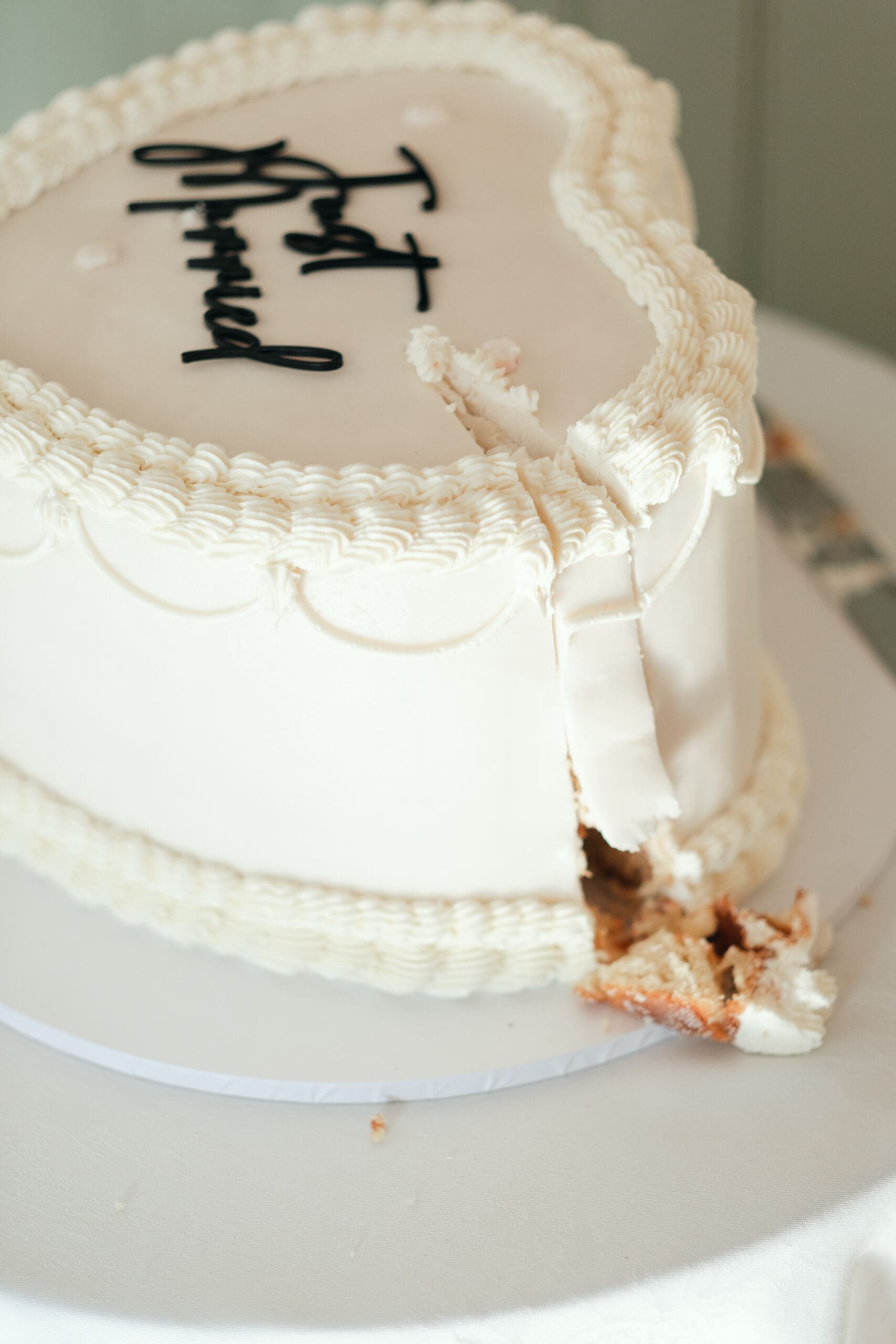 Wedding cake cutting photographed inside The Hop Rooms, Cambridgeshire