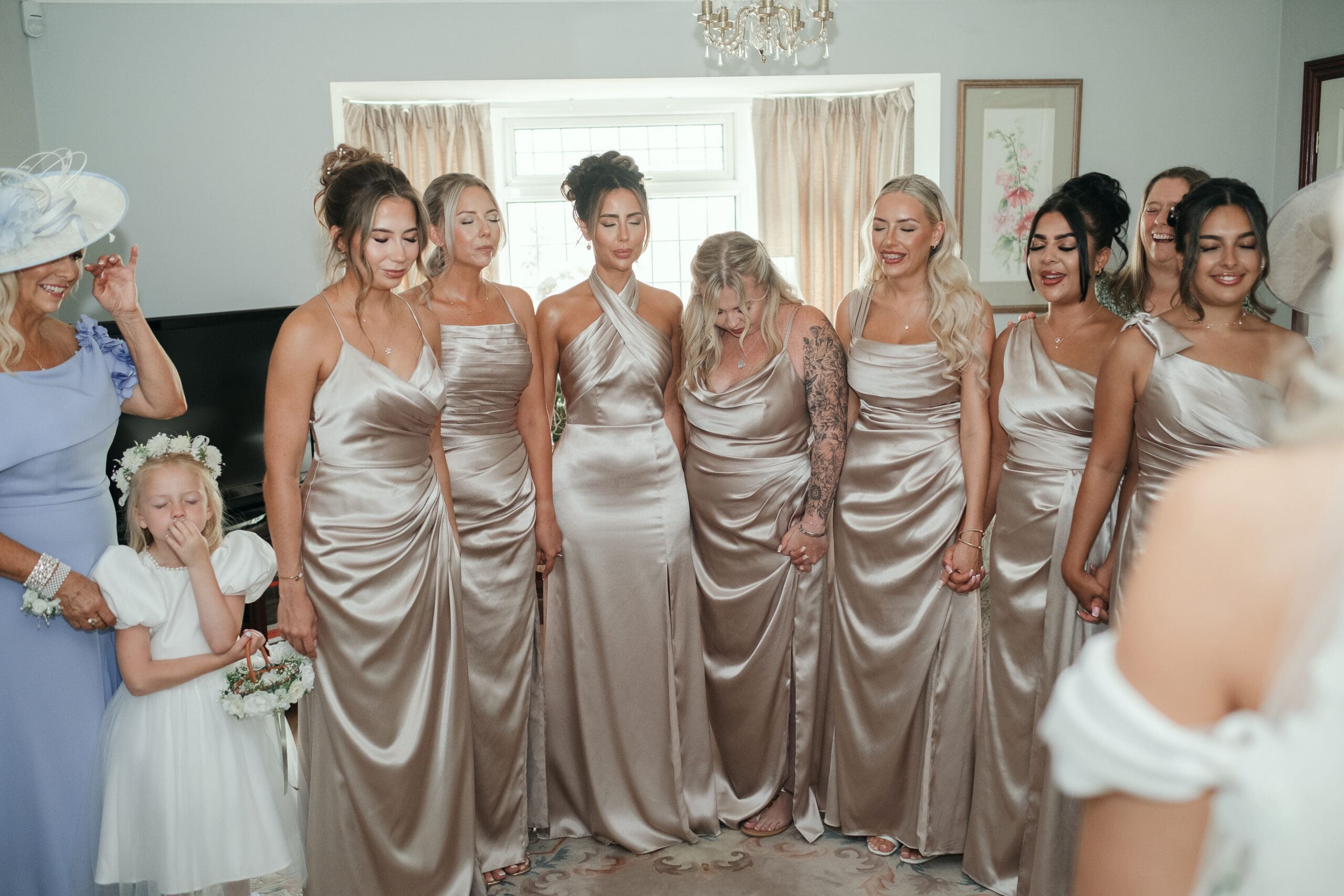 Bridesmaids reacting with joy during the bride’s first look moment