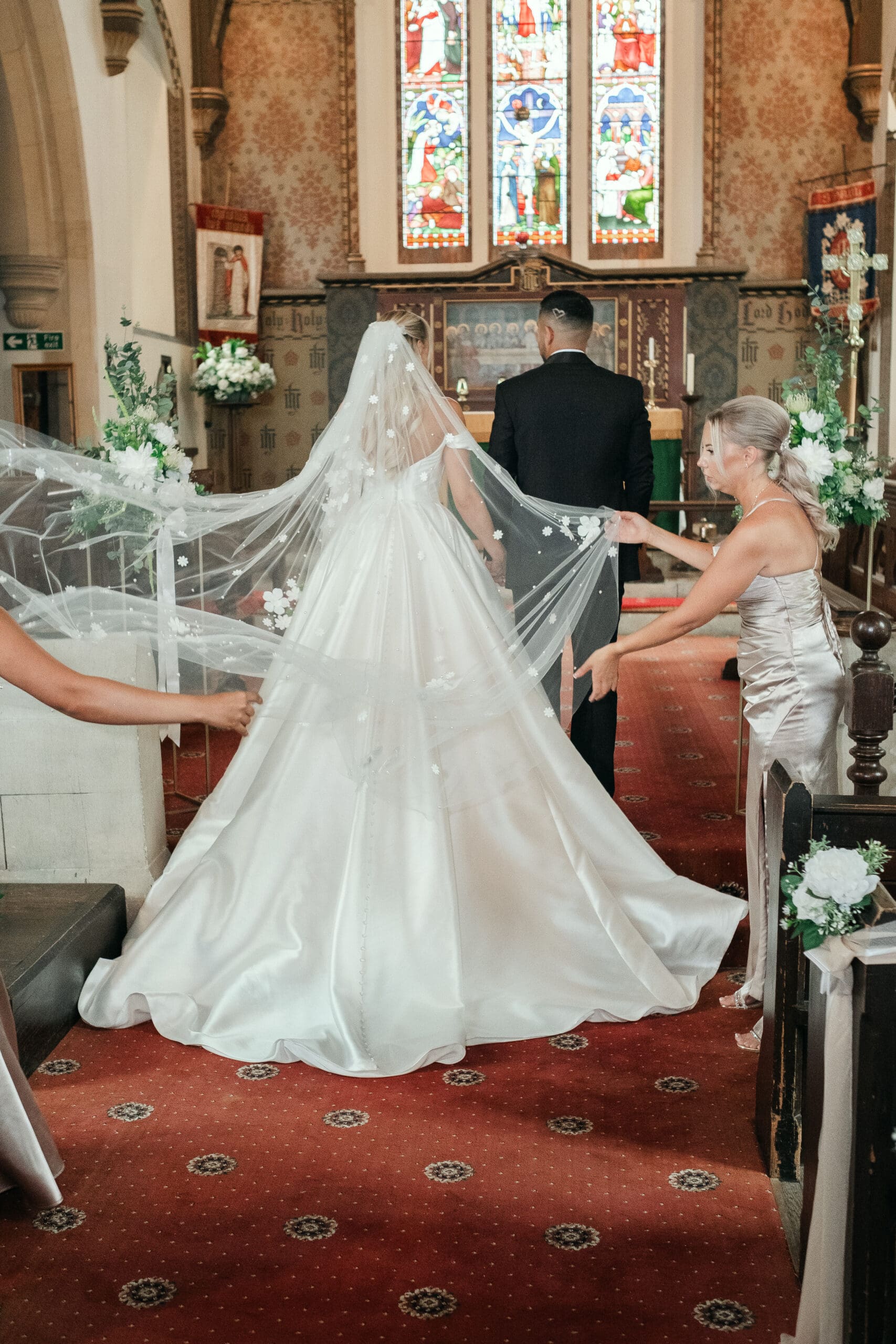 Newlywed couple posing by St Paul’s Church during their Wisbech wedding day