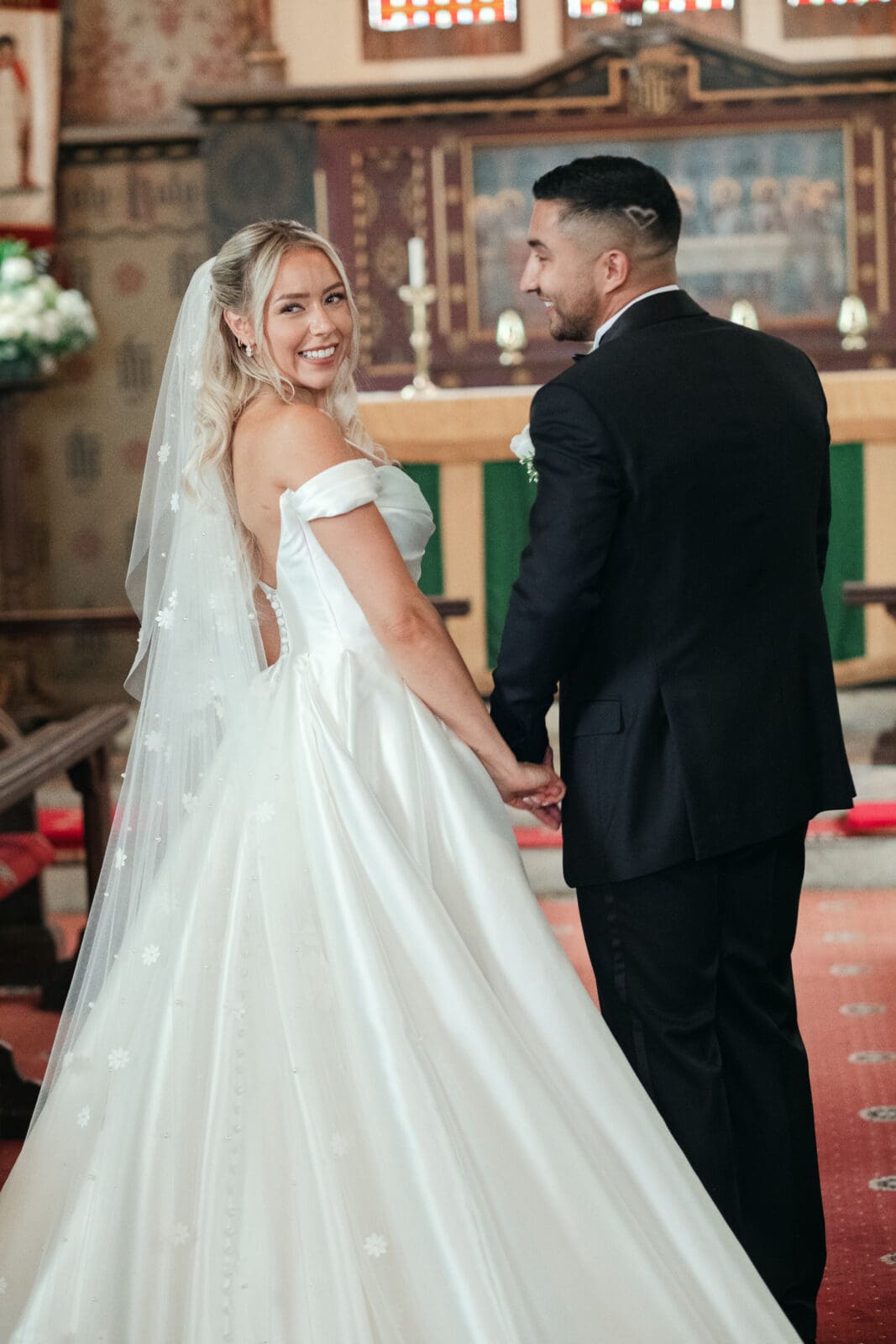 Newlywed couple posing by St Paul’s Church during their Wisbech wedding day