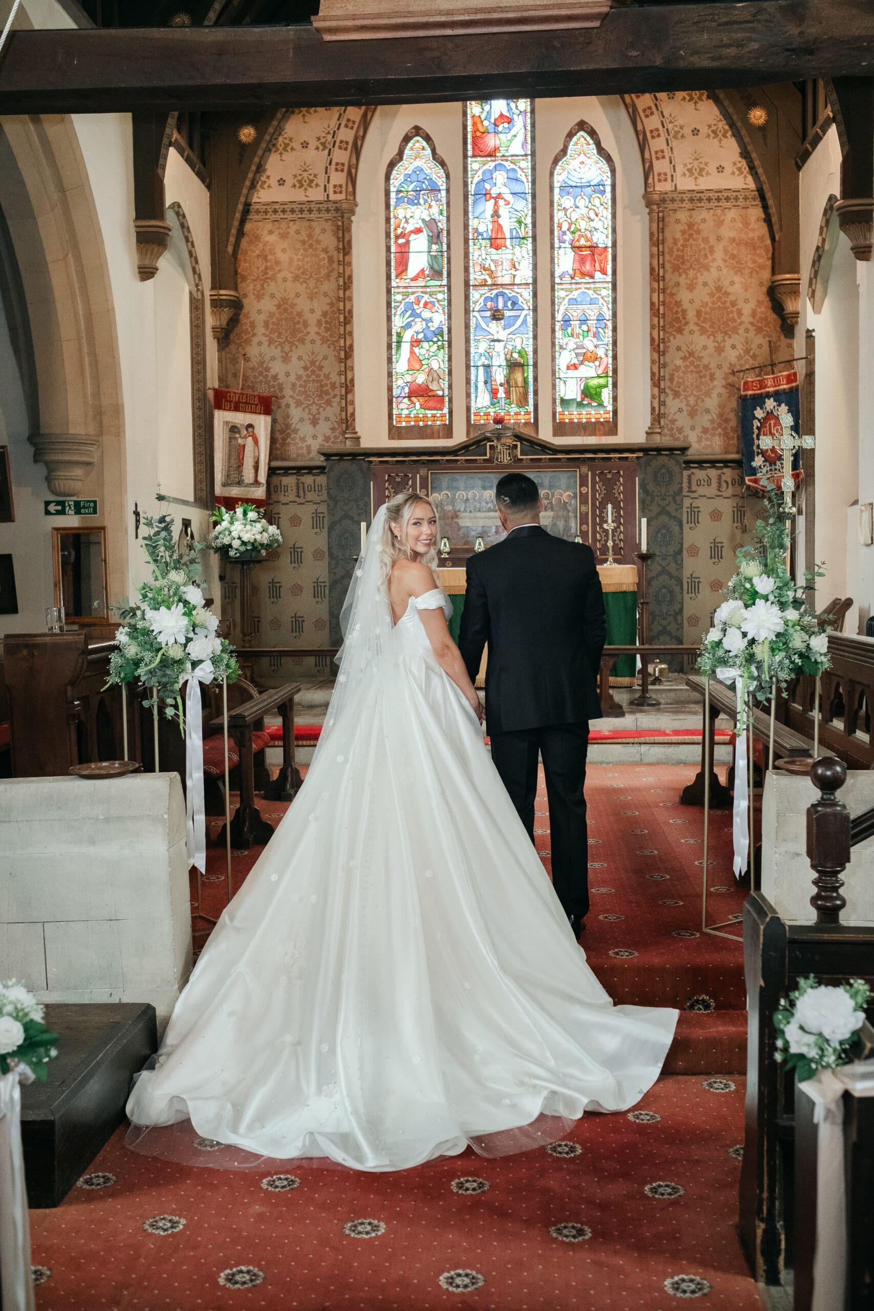 Newlywed couple posing by St Paul’s Church during their Wisbech wedding day
