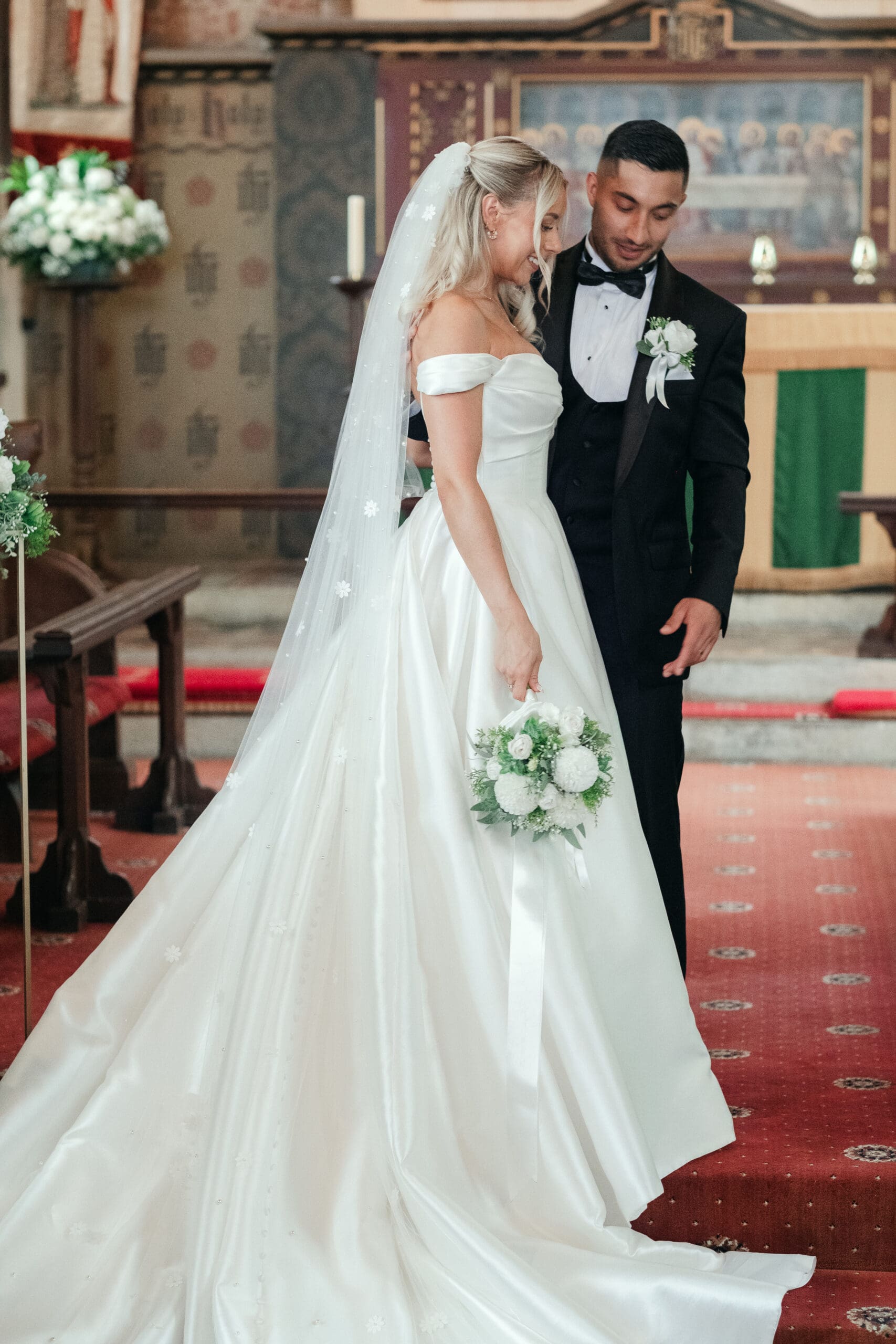 Newlywed couple posing by St Paul’s Church during their Wisbech wedding day
