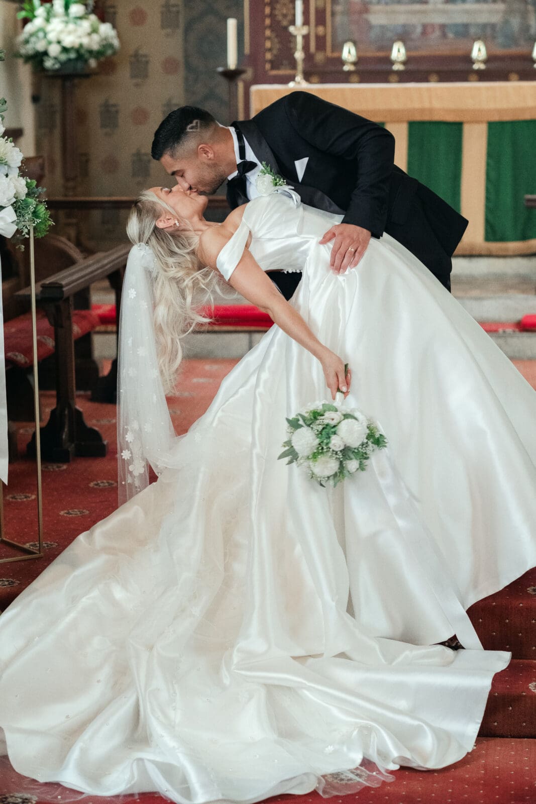 Newlywed couple posing by St Paul’s Church during their Wisbech wedding day