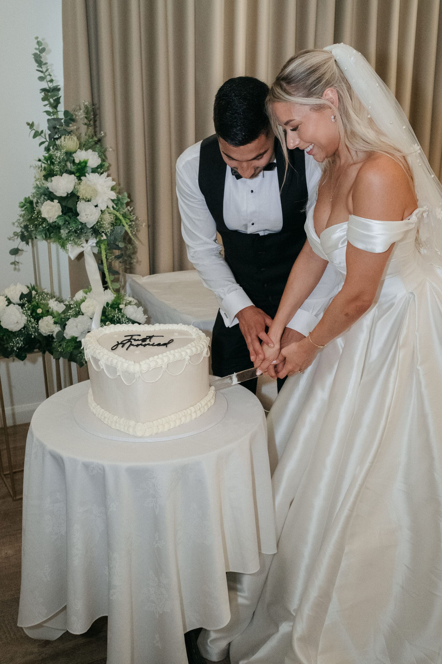 Bride and groom cutting their wedding cake at The Hop Rooms in Wisbech